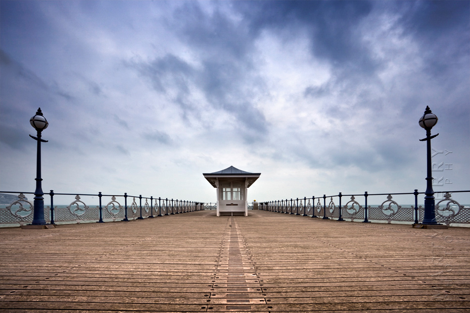 Atmospheric image of Swanage pier under stormy clouds