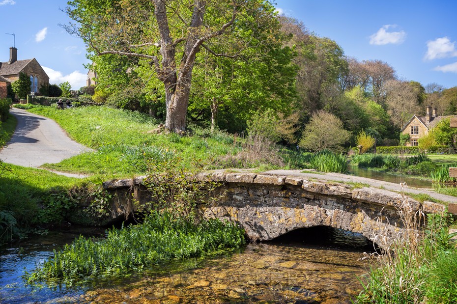 Ancient stone bridge at Upper Slaughter in the Cotswolds