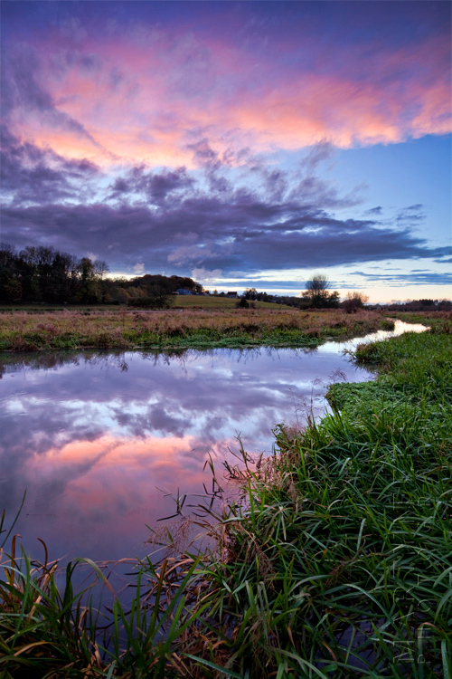 Sunset colours reflected in the river windrush