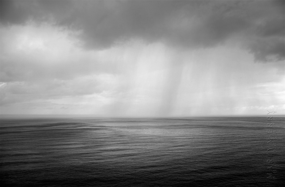 Dramatic image of rain falling onto the ocean