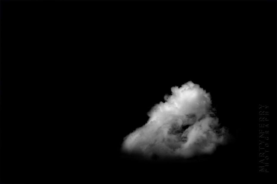 Fine art photography of clouds floating in black nothingness