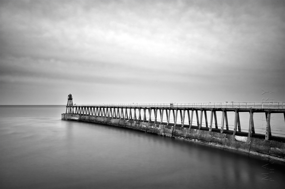Dramatic photograph of Whitby pier in black and white