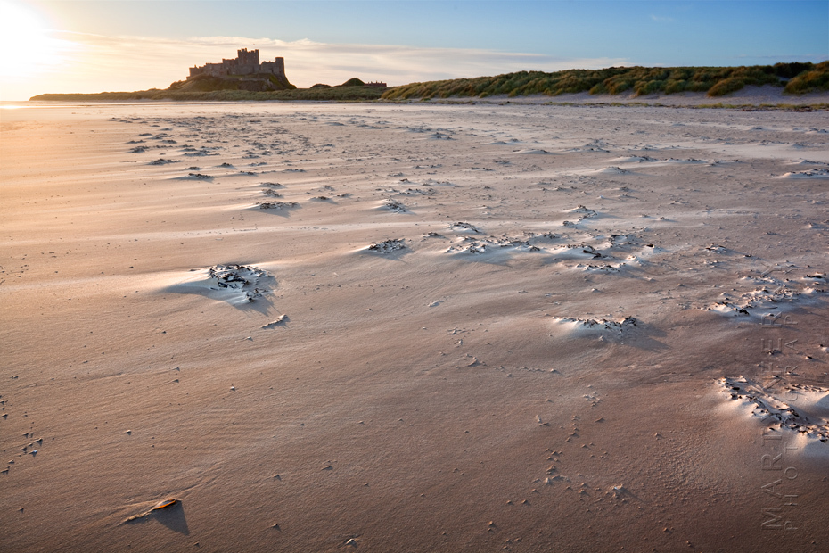 Sunrise over the windswept beach at Bamburgh
