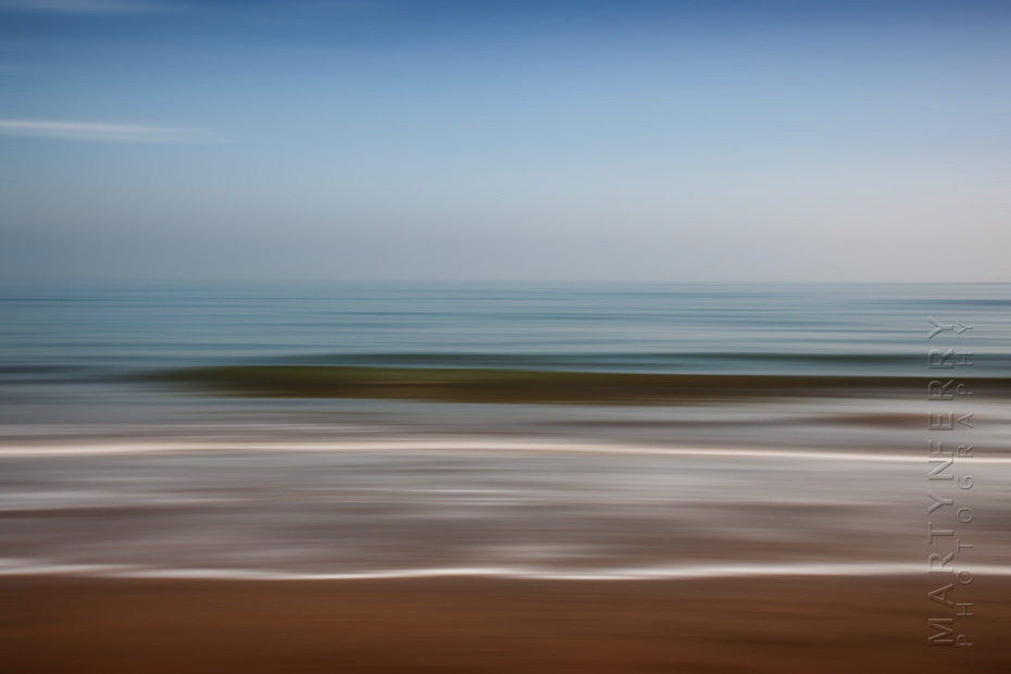 Beautiful minimal photograph of beach waves and sky in Dorset