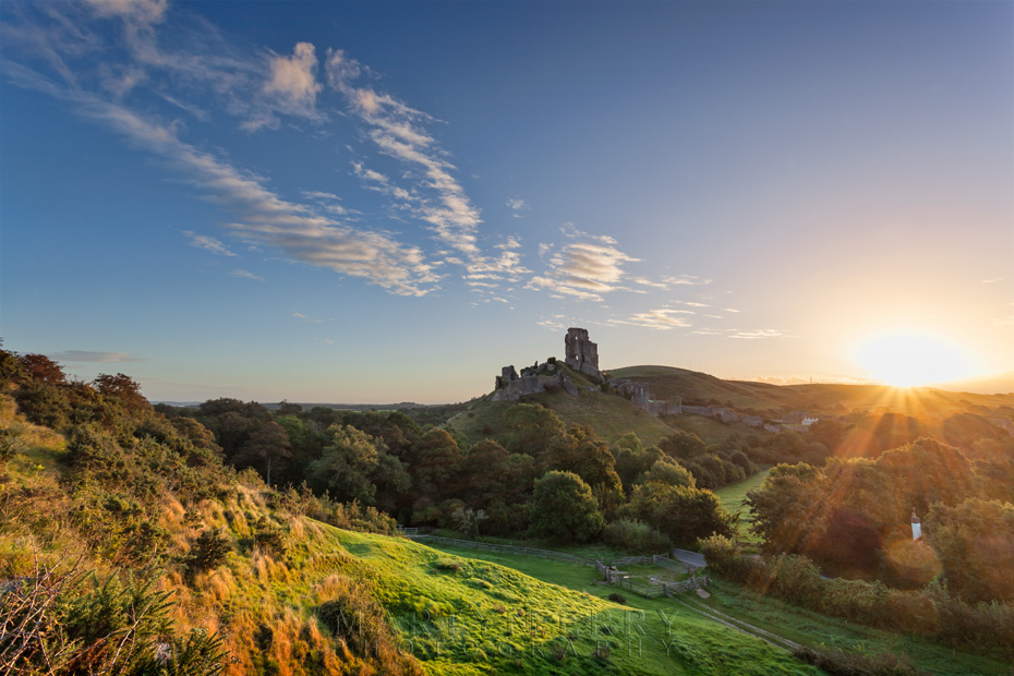 Sunrise behind the iconic ruins of Corfe Castle in Dorset