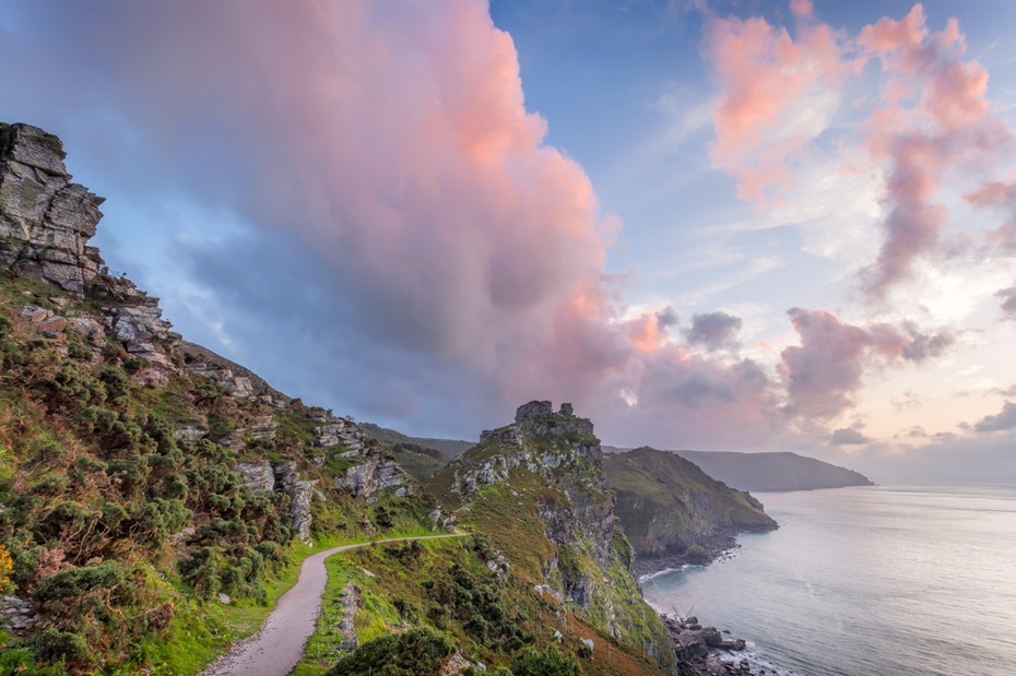 Beautiful pink clouds over Castle Rock at Valley of Rocks in Exmoor