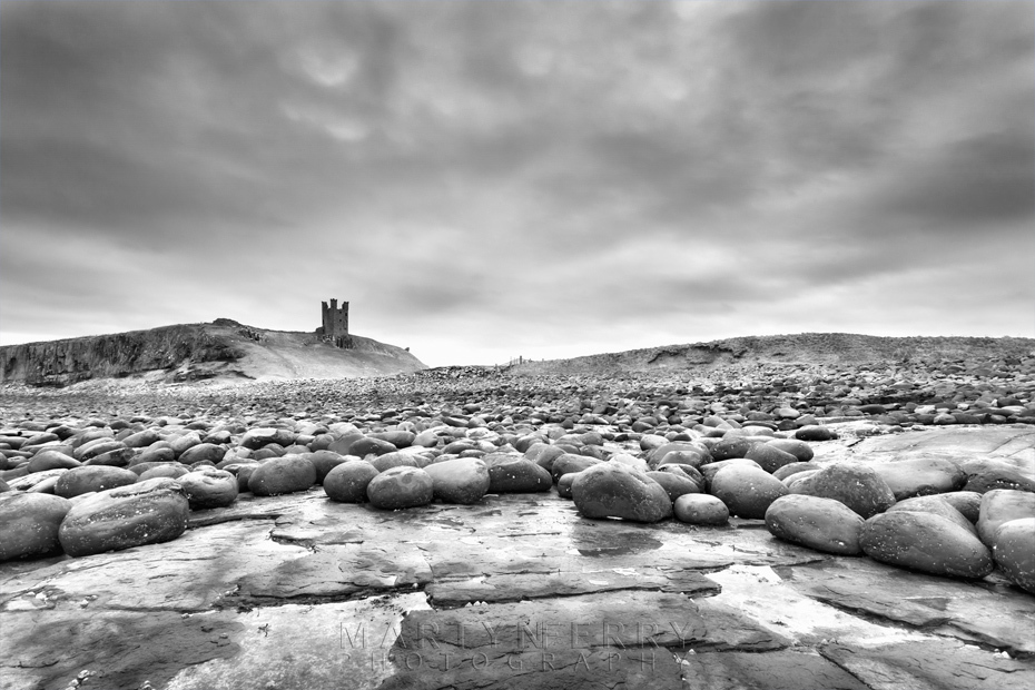 Dunstanburgh Castle in black and white