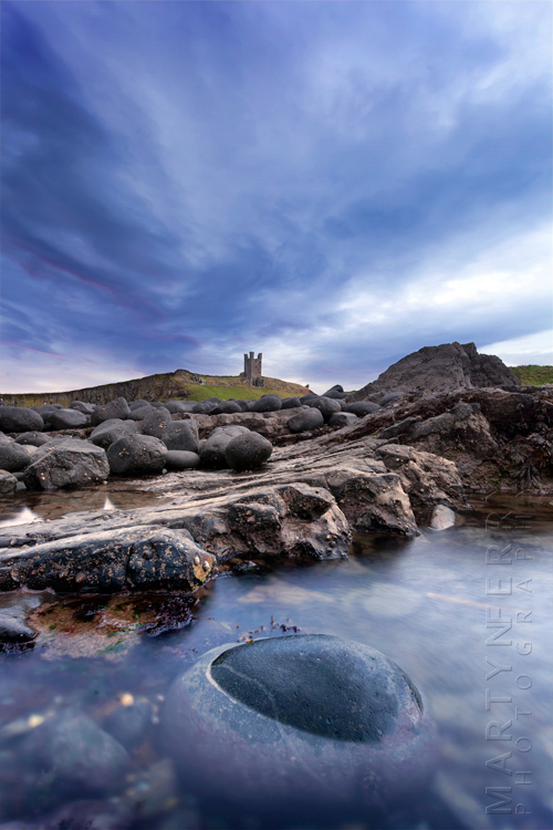Coastal landscape at Dunstanbrugh under stormy clouds