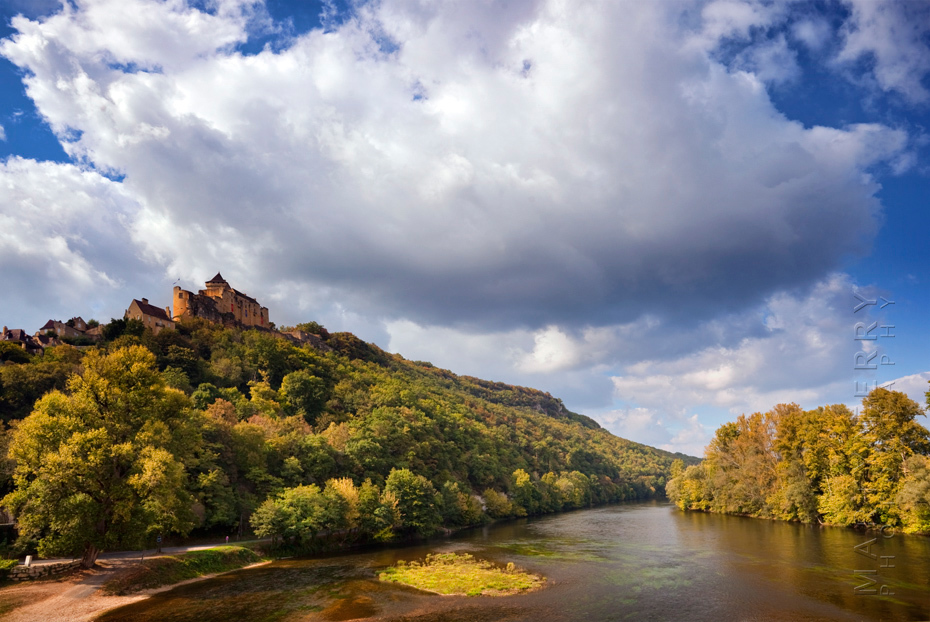 Beautiful image Chateau Castelnaud under a summer cloud