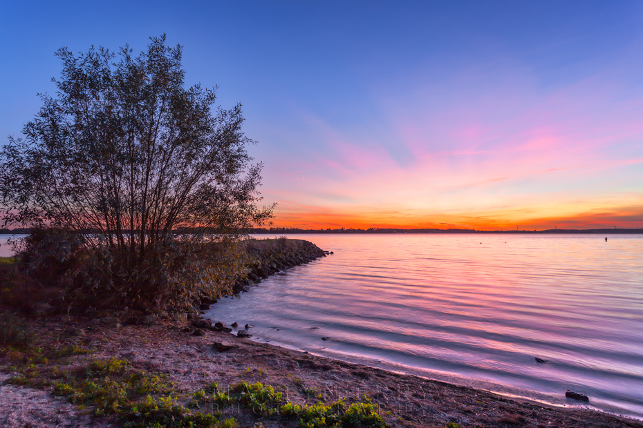 Grafham Water sunset colours reflect in the reservoir