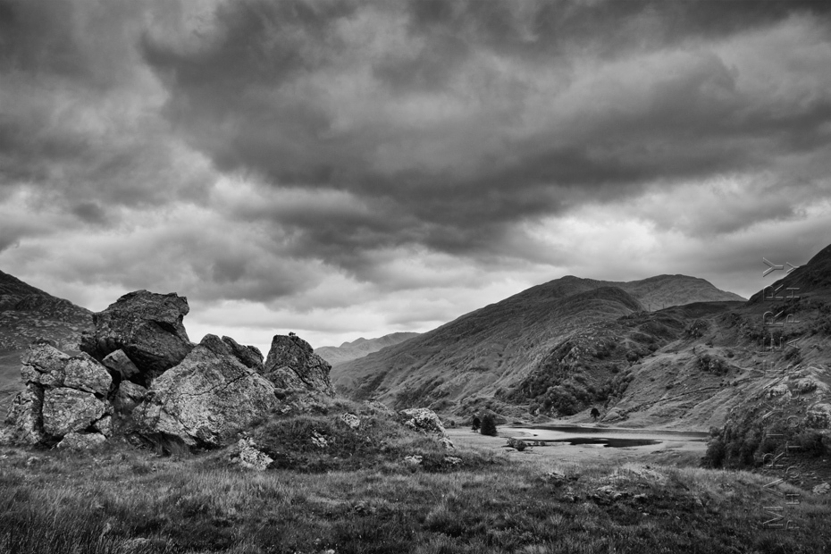 Landscape image of Loch Coire Shubh and foreground rocks