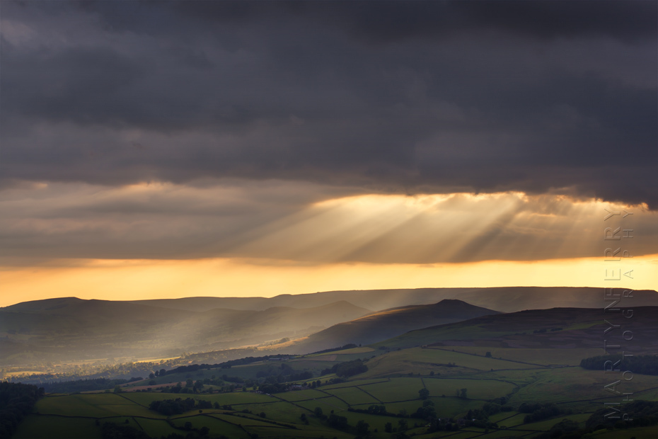 Sunbeams break through the clouds at Stanage Edge