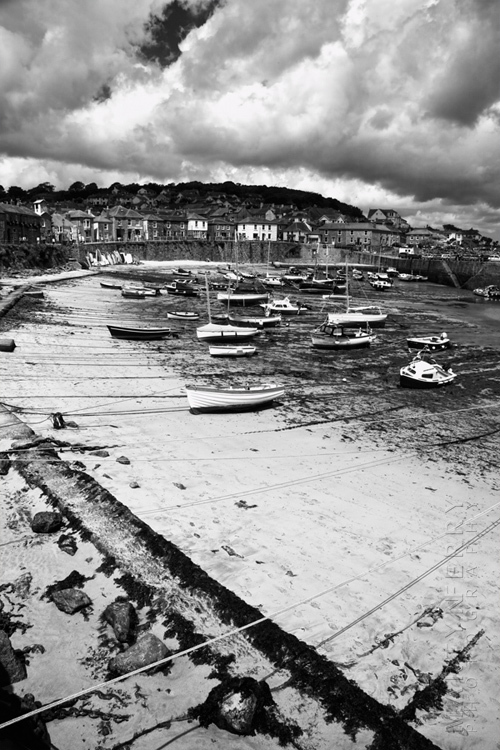 Striking black and white image of Mousehole harbour