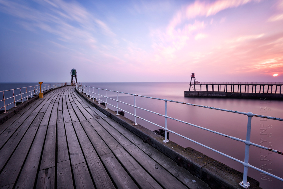Beautiful photograph of Whitby piers at sunrise