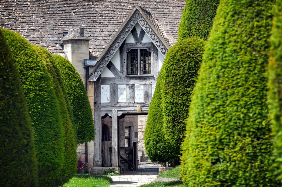 Green yew trees in front of the Lych Gate in Painswick