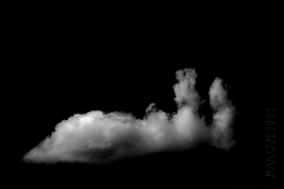 Fine art photography of clouds floating in black nothingness