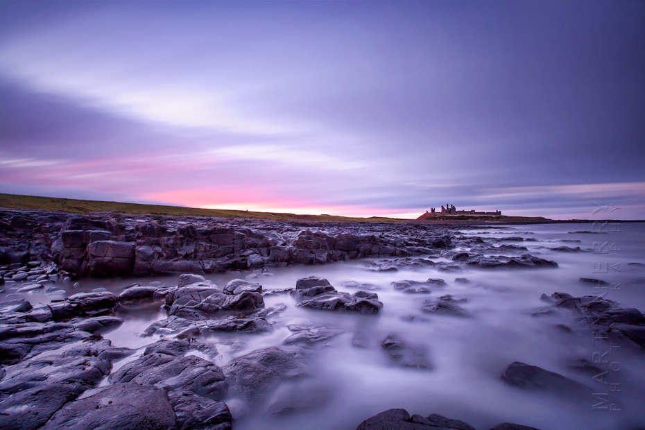 Sunset colours over Dunstanbrugh Castle in Northumberland