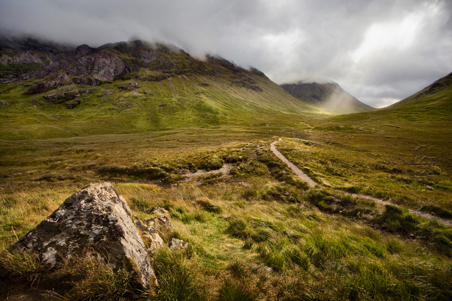 Image of sunlight breaking through clouds in the distance at Etive Mor