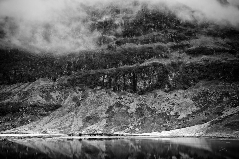 Dramatic photograph of Loch Achtriochtan with low cloud