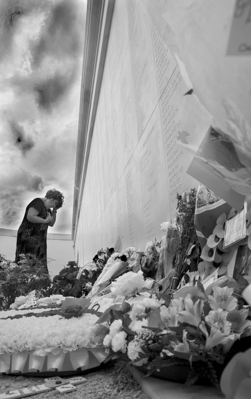 Viewing floral tributes bw - National Memorial Arboretum, Staffordshire, England