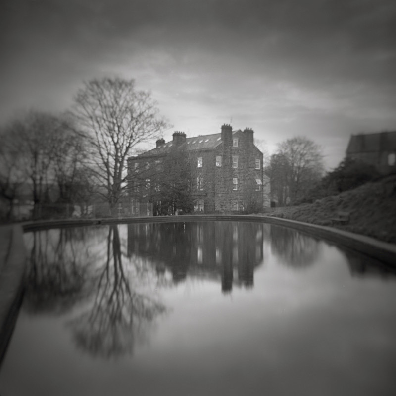 Black and White Photograph of Reflections of a Victorian Building in Ilkley