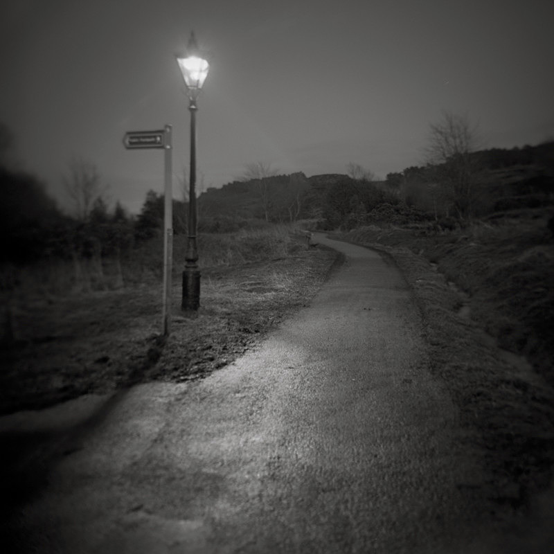 Black and white Photograpth of The Tarn Path approach Ilkley at night in street lighting