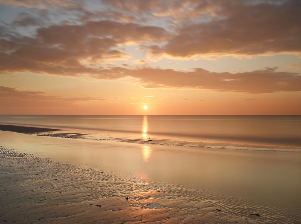 Limited edition photograph of the North Norfolk coastline at Brancaster Beach titled “Sun Setting”
