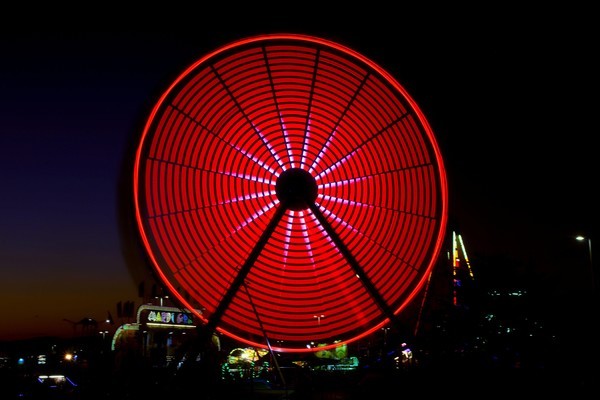 Red Spinning Ferris Wheel - Architecture and Night Skyline