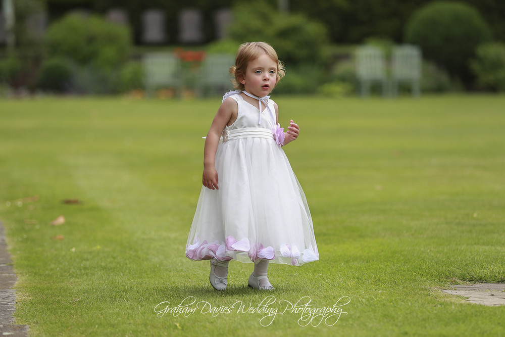 Miskin Manor flower girl playing - Wedding Photography at Miskin Manor