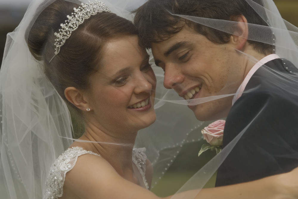 Bride & Groom under the veil at Caerphilly Castle - Wedding Photography at Caerphilly Castle
