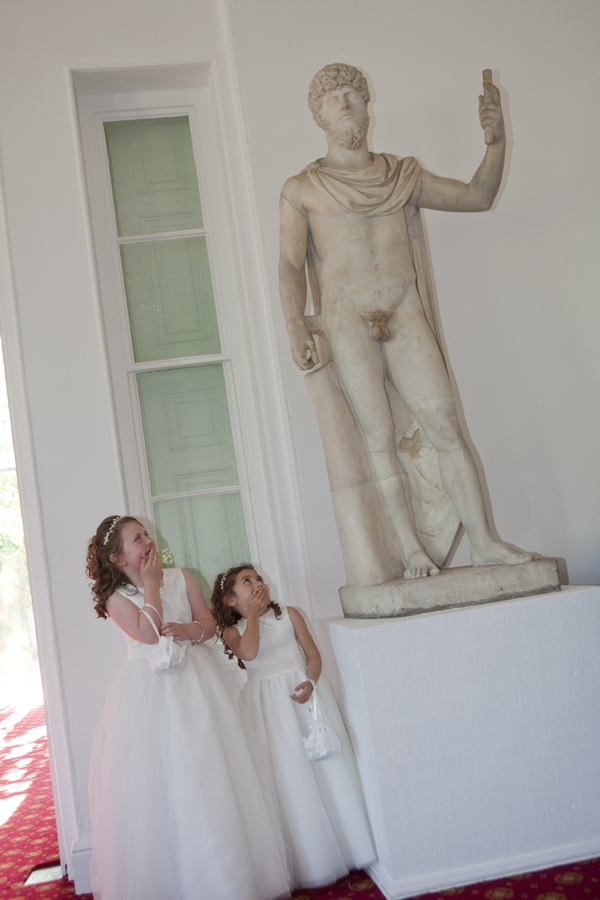 Two little brides maids giggling at statue in Margam Orangery - Wedding Photography at Margam Orangery